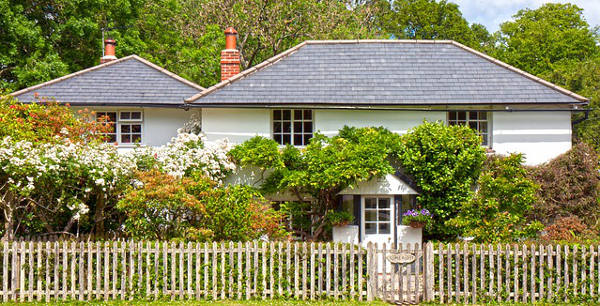 Two-story home with picket fence