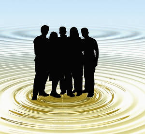 Silhouetted group of people standing in a liquid ripple